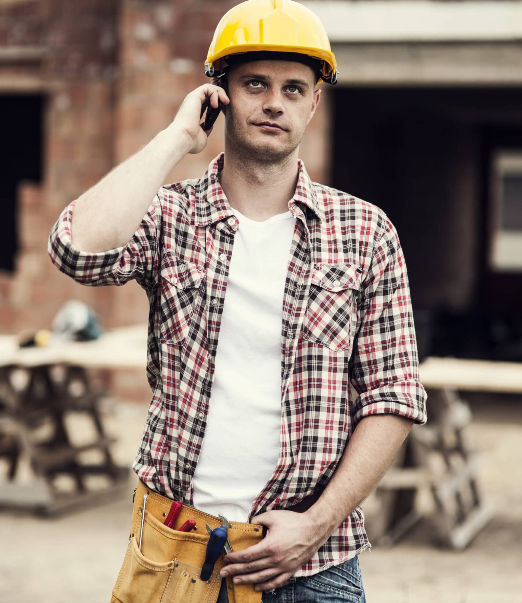 Construction worker with mobile phone