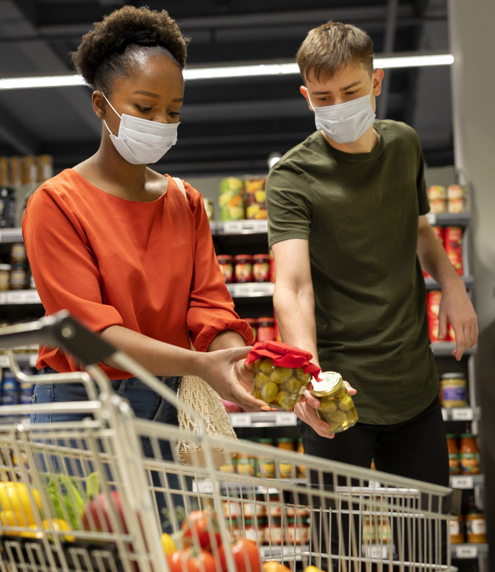 man-woman-with-medical-masks-out-grocery-shopping-with-shopping-cart