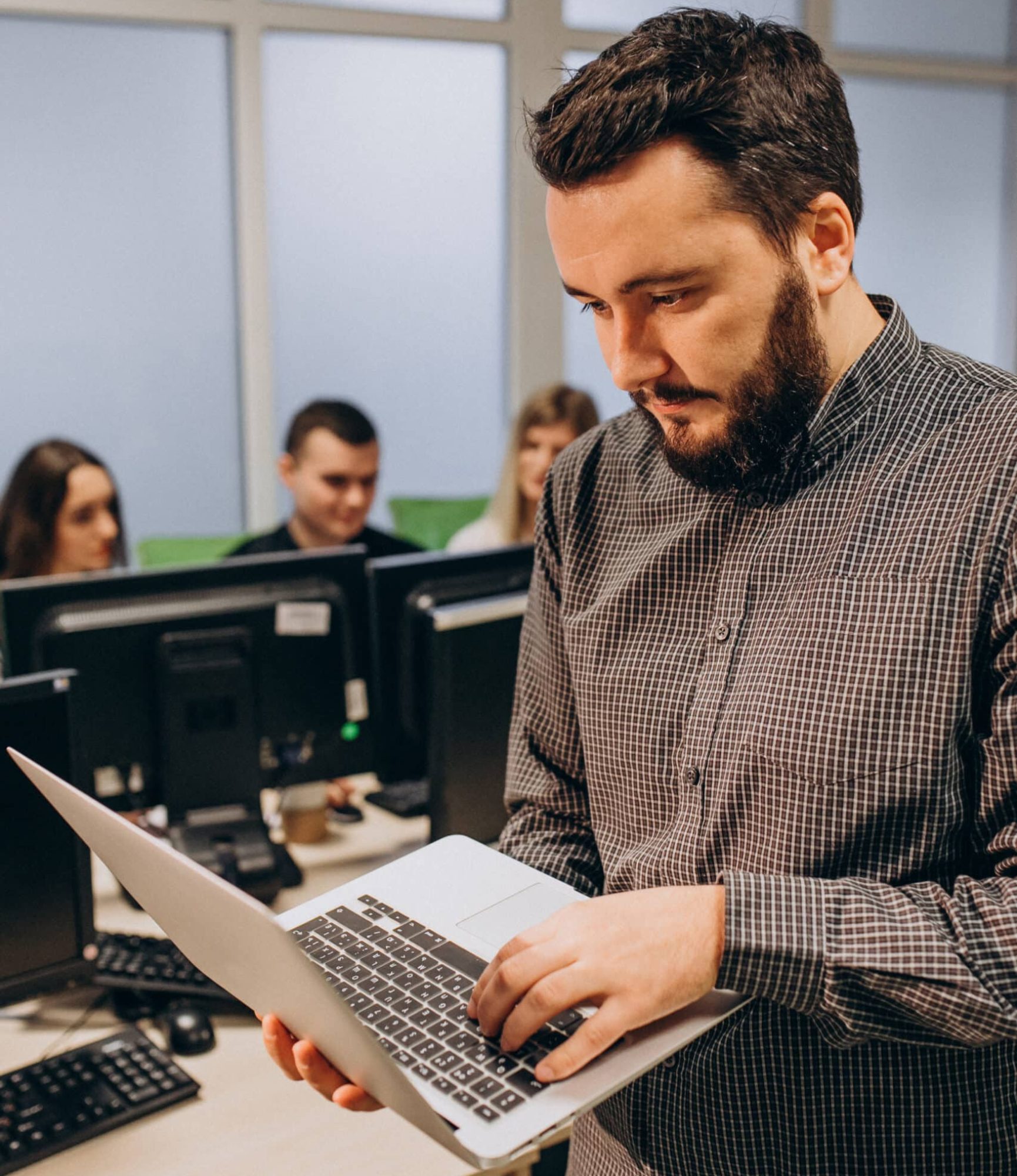Workers at an IT company working on a computer